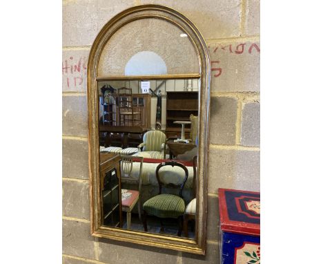 A modern gilt framed wall mirror, the arched top with an inset lacework panel, width 59cm, height 112cm