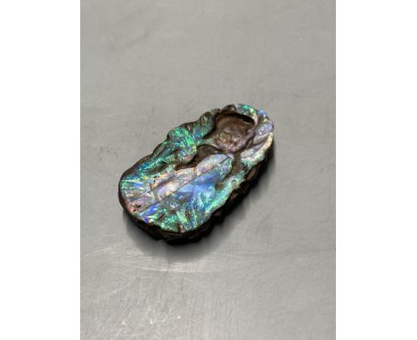 A Chinese carved Australian boulder opal pendant with flowers to the front and fruit to the back, 4.5cm, gross 17.1 grams.