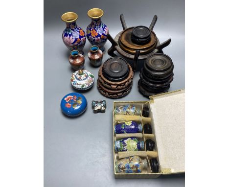 A group of Chinese wood stands and cloisonne enamel vases