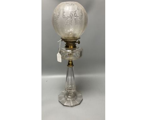 A late 19th century cut glass oil lamp with floral embossed shade, 61cm high including shade