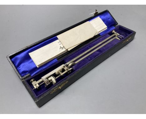 A vintage polished steel planimeter by M.D.S, cased with illustrations
