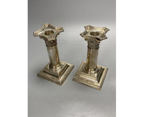 A pair of late Victorian silver dwarf candlesticks, Henry Matthews, Birmingham, 1895, 14.2cm, weighted.CONDITION: The top of 