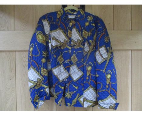 A 1980s Givenchy En Plus padded jacket having a blue ground with images of script, sword handles and tassels UK size 16Locati