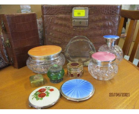 Three silver and enamel topped glass dressing table pots, marks rubbed to the lid of the pink lid, together with a vintage cr