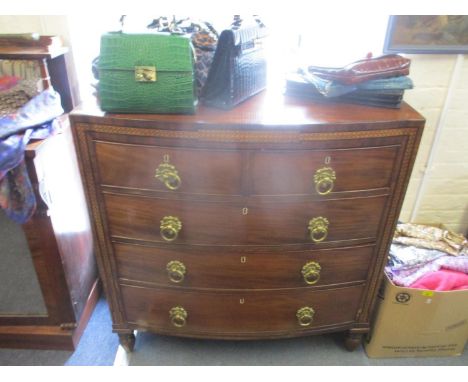 A 19th century mahogany bow fronted chest of two short and three long drawers with inlaid decoration on turned legs 106cm x 1