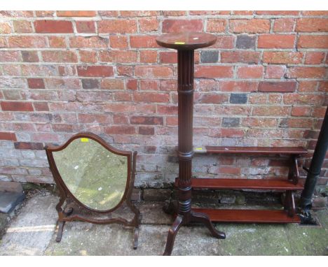 A mahogany pedestal torchere stand, an Edwardian mahogany shield shaped swing mirror, and a three tier mahogany wall hanging 