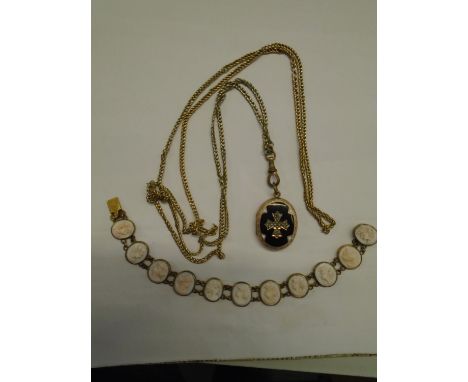 A Victorian gold plated and black enamel pendant locket decorated with split seed pearls in a cross configuration, on a chain