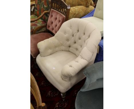 A Victorian style button upholstered armchair.