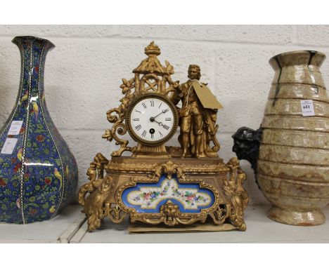 A French gilt decorated spelter mantle clock with porcelain panels.