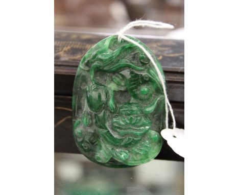 A carved jade amulet.