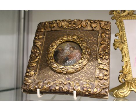 A small gilt framed enamel plaque.
