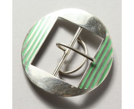 A silver buckle with green enamel decoration.