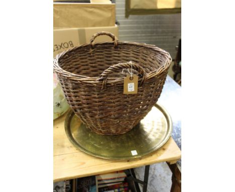 A wicker basket, eastern brass tray and a floor standing lamp.