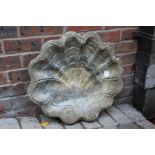 A shell shaped birdbath top.