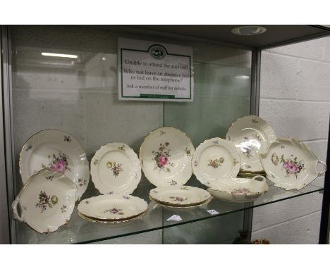 A quantity of Royal Copenhagen porcelain plates and serving dishes, cream ground with floral decoration.