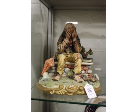 A Capodimonte figure, tramp on a bench.