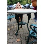A Victorian pub style circular cast iron table.