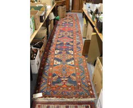 A good Persian runner / hall carpet, blue ground with stylized decoration.
