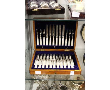 A cased set of eighteen mother-of-pearl handled fruit knives and forks (lacking one knife).