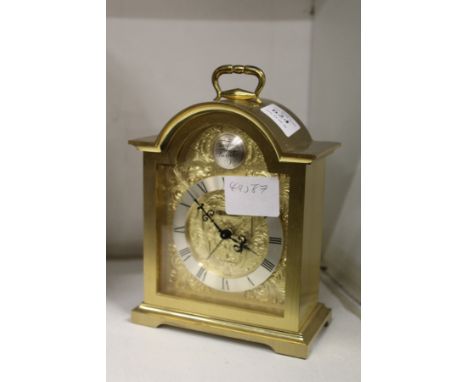 A Swiza brass mantle clock.