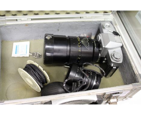 A Leicaflex 35mm camera with two lenses and an aluminium case.