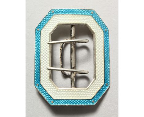 A silver and turquoise enamel buckle.