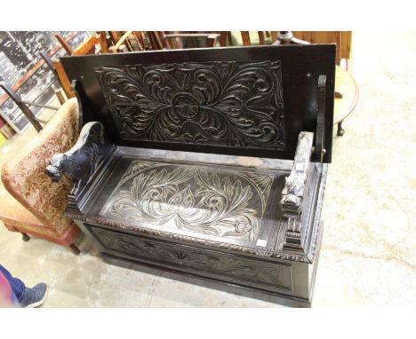 A carved oak monk's bench.