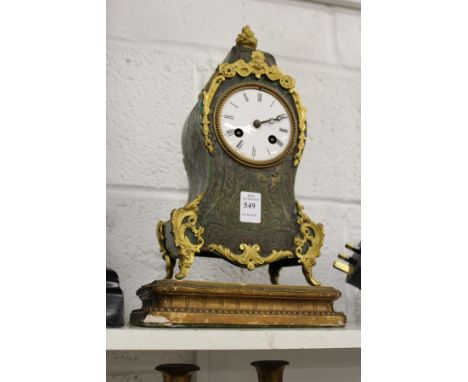 A French green tortoiseshell and ormolu mantle clock in the manner of Boulle.