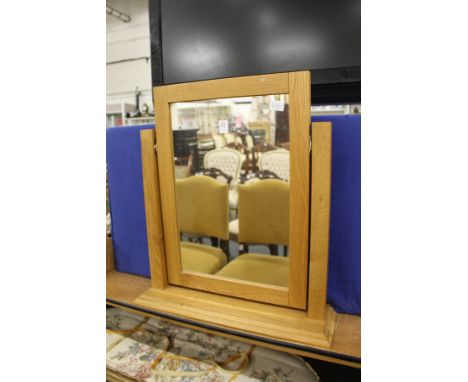 A modern light oak dressing table mirror.