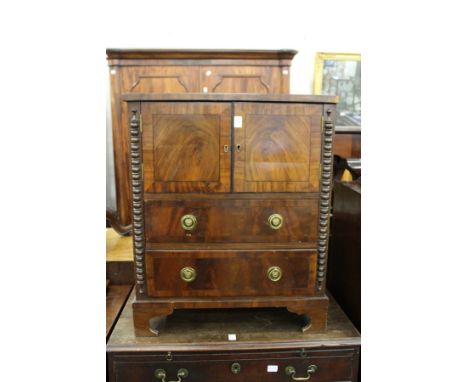a 19th century mahogany commode with two doors and two long drawers on bracket feet.