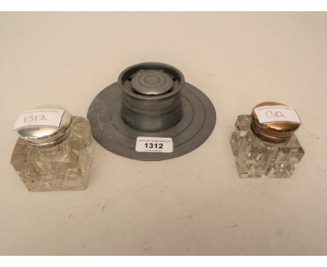 Pewter capstan inkwell together with two glass inkwellsInkwell on the left - 2ins x just under 2.5insInkwell on the right - 2
