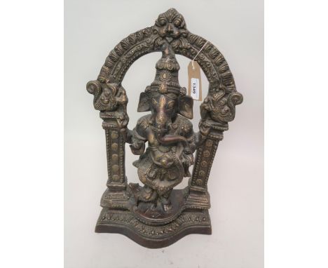 20th Century dark patinated bronze figure of Ganesh beneath an archway on a shaped plinth base, 19ins high 