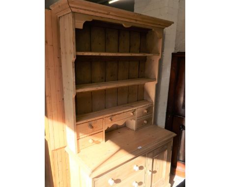 Victorian stripped pine dresser, the boarded shelf and drawer back above three drawers and a single panelled door with knob h