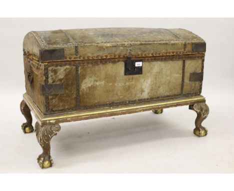 Late 18th / early 19th Century hide covered dome top trunk with iron side handles on a later gilded stand with carved cabriol