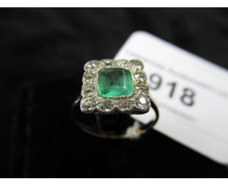 18ct Yellow gold ring set square emerald surrounded by twelve diamondsSlight signs of wear but no damage or repair. The centr