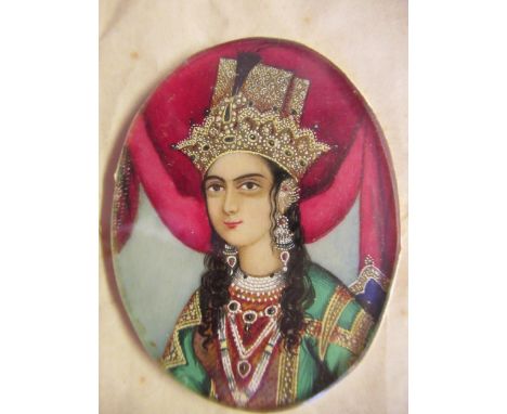 19th Century Indian school, watercolour portrait miniature of a lady wearing an ornate headdress, 2ins x 1.5ins approximately
