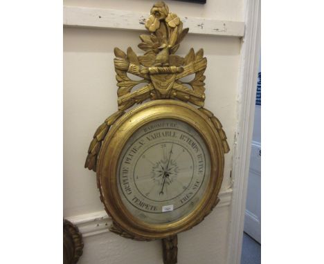 19th Century French giltwood mercury barometer, the oval case with bird, torch and quiver surmount and printed paper dial, 35