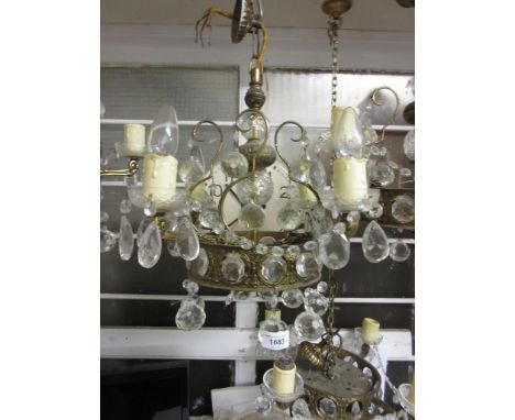 Set of three mid 20th Century gilt brass and glass four light electroliers, each with a baluster centre surrounded by prismat
