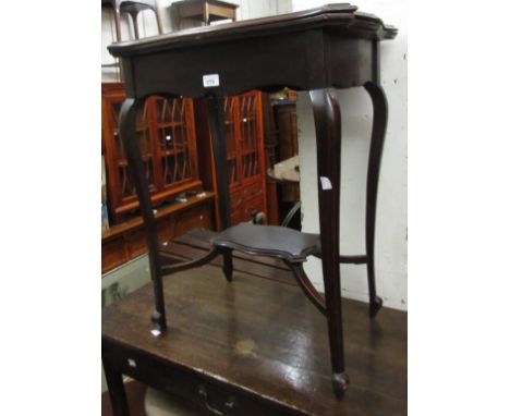 Small Edwardian mahogany card table, the shaped fold-over top above cabriole supports and undertier, 22.5ins wide 