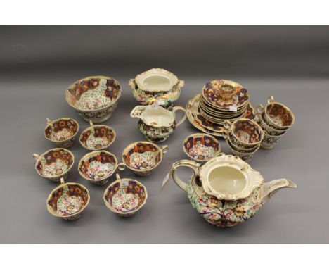 English 19th Century porcelain part tea service floral decorated in red, blue, green and gilt including a teapot and sucrier 