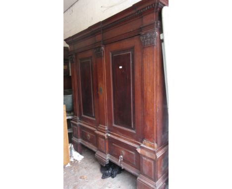 19th Century Continental walnut armoire, the heavy moulded and dentil cornice with a shaped surmount above a pair of rectangu