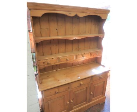 20th Century stripped pine dresser having a boarded shelf back with three small drawers above three further drawers and three