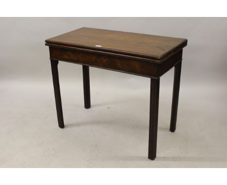 George III mahogany rectangular fold-over card table with a plain frieze and four square cut chamfered and moulded supports, 