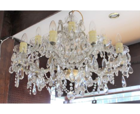 Mid 20th Century glass and gilt brass fifteen light electrolier with shaped arms and multiple prismatic swags and drops, 28in