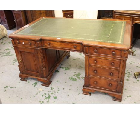 Reproduction mahogany twin pedestal partner's desk, the shaped moulded top above an arrangement of various drawers, cupboard 