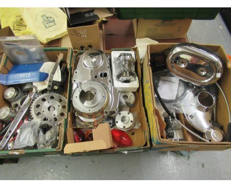 Three boxes containing a large quantity of various Harley-Davidson parts including chrome covers, foot pegs, wheel hub, dials