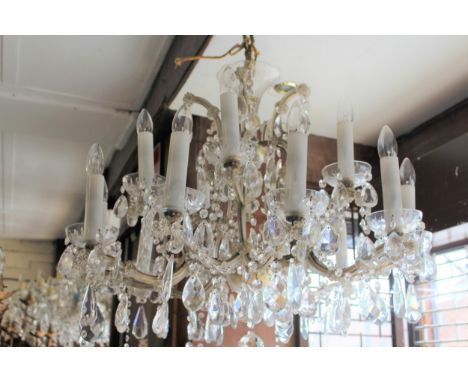 Mid 20th Century glass and gilt brass fifteen light electrolier, the shaped arms with multiple prismatic drops and swags, 28i