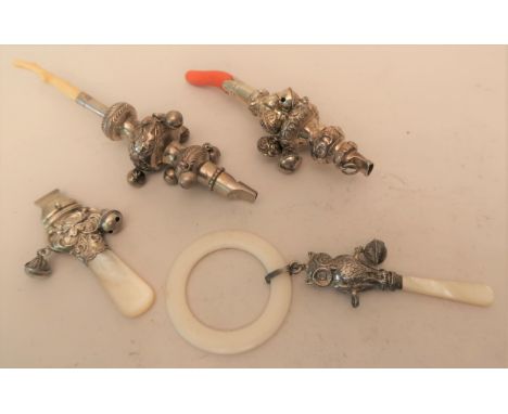 Babies Birmingham silver rattle / teether in the form of an owl with mother of pearl handle, together with three similar whit