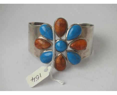 Unusual wide silver bangle with hardstone set flower motif   47g inc         