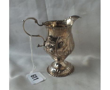 George III helmet shaped cream jug with embossed sides and pedestal foot, 4” over handle Lon by CH    